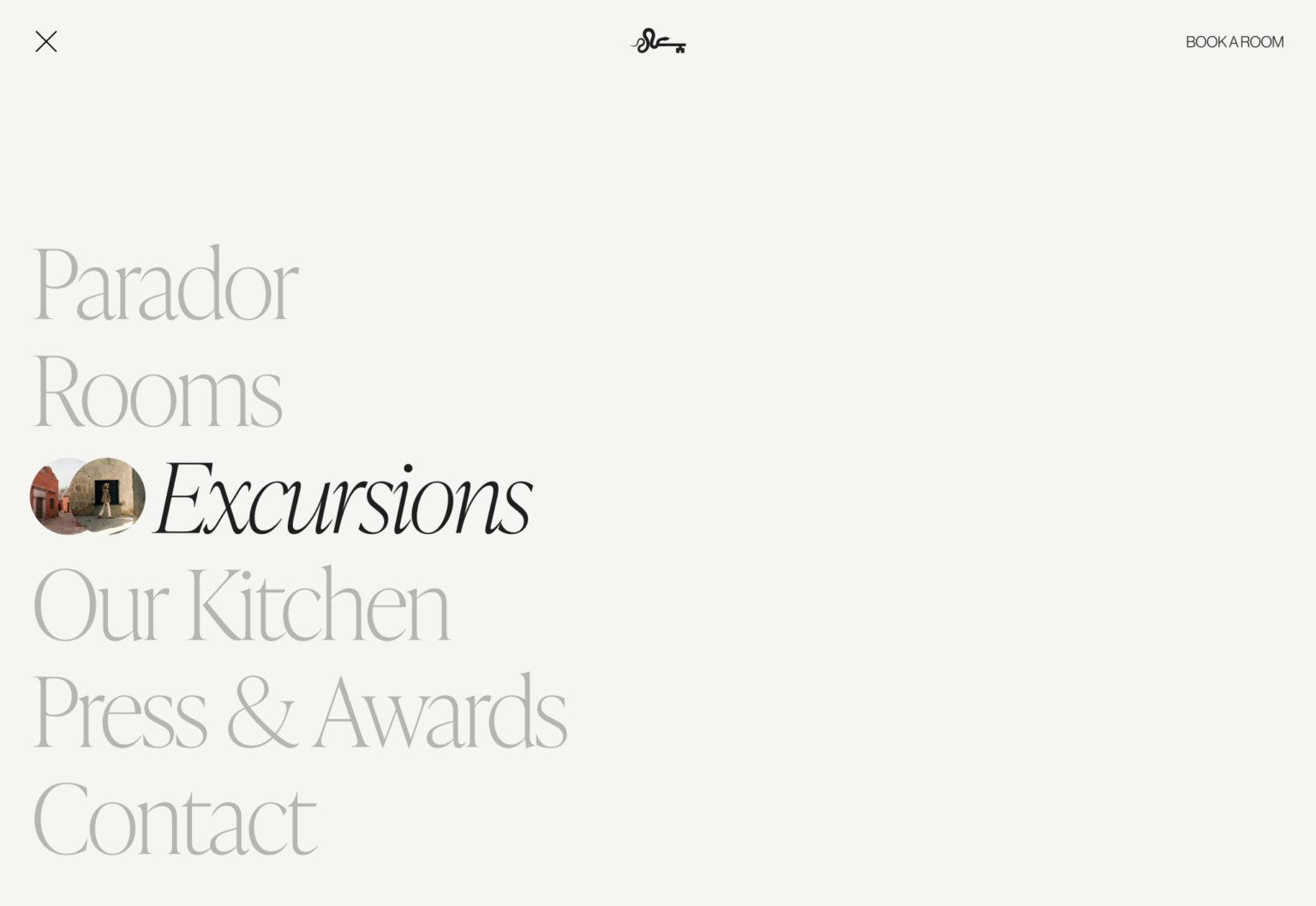 Website menu listing Parador, Rooms, Excursions, Our Kitchen, Press & Awards and Contact on cream, for Cirqa.